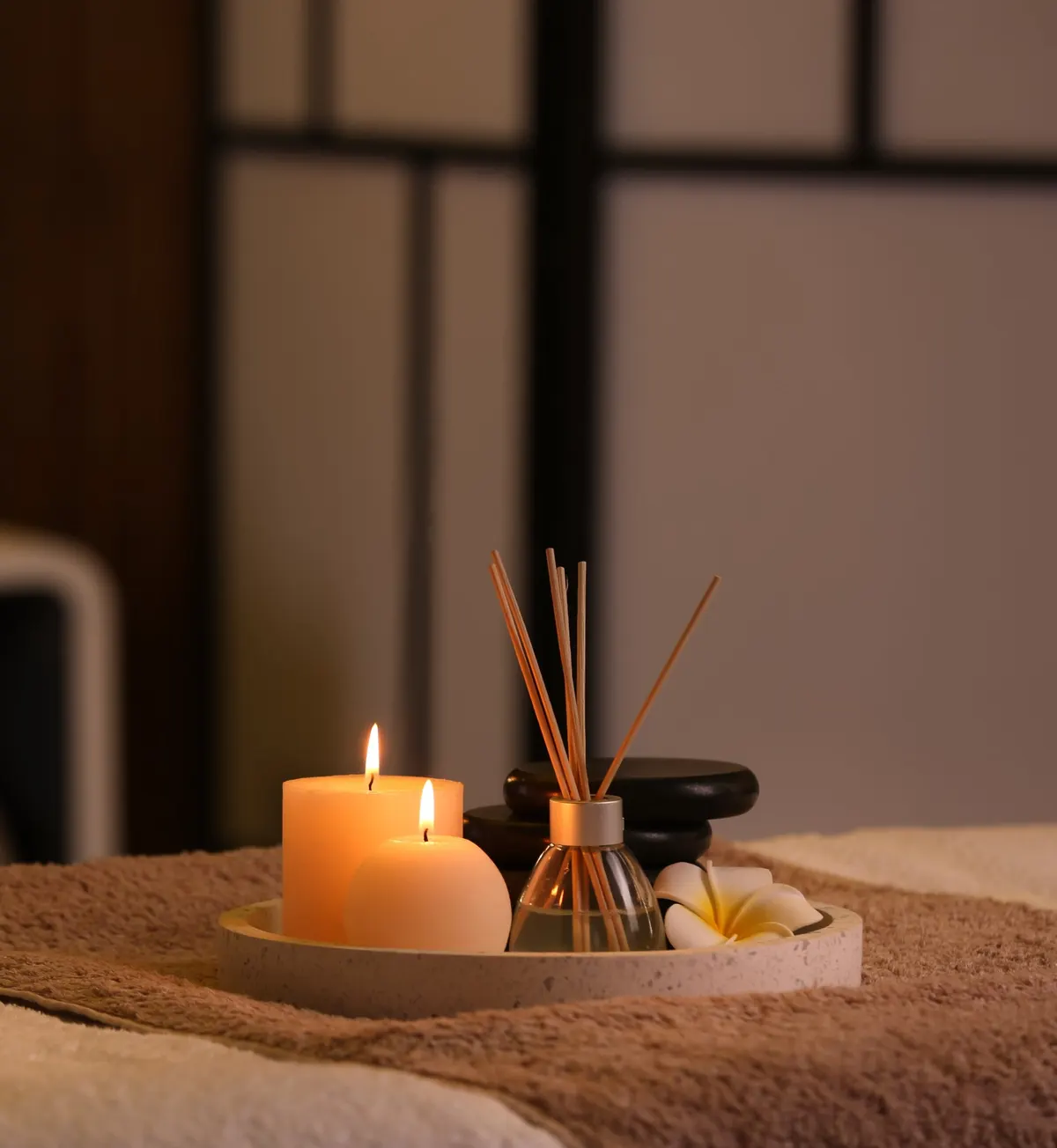 Candles and diffuser in a calm spa setting
